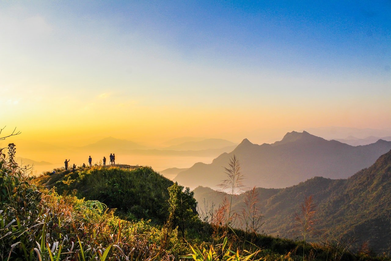 Travel tour Photo Of People Standing On Top Of Mountain Near Grasses 733162